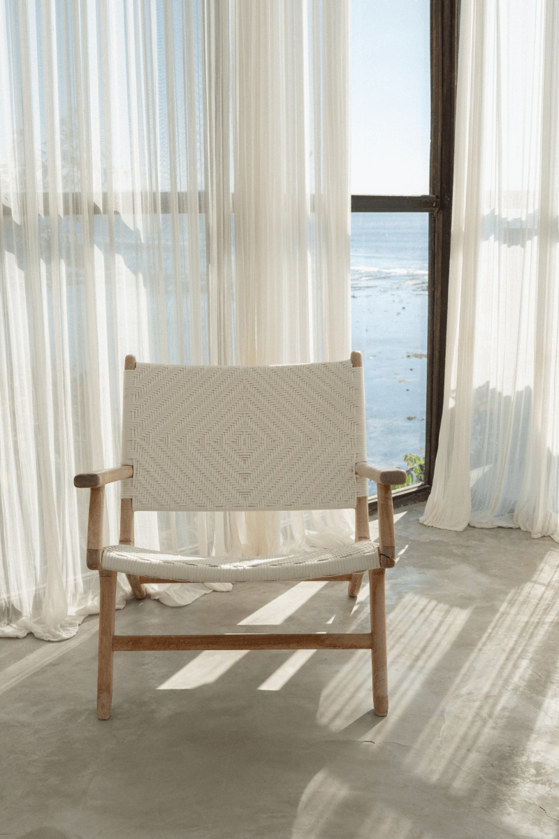 Chair by window with ocean view.